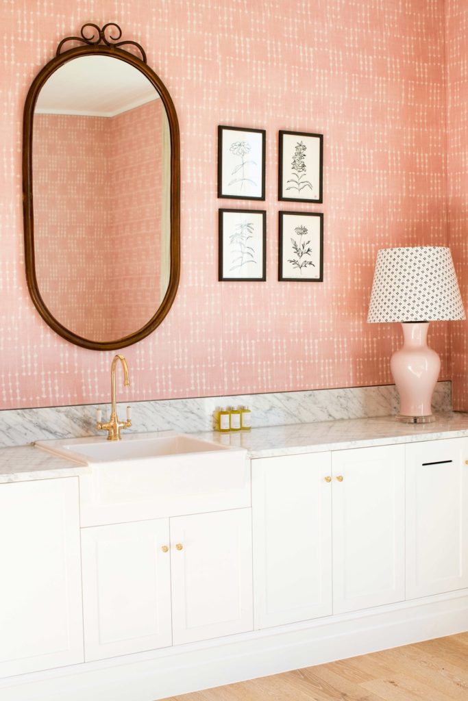 pink bathroom with gold lamp