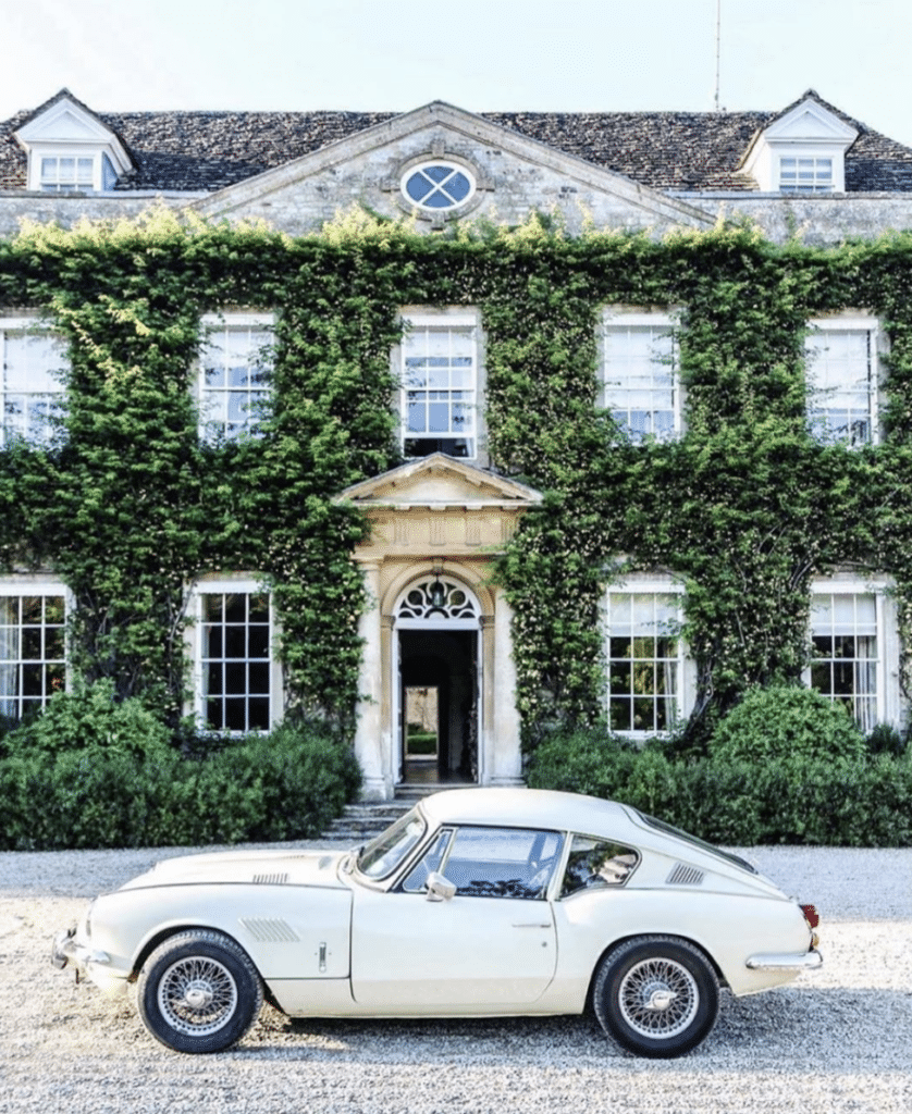 ivy covered house with sportscar