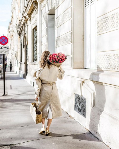 woman walking in paris with flowers