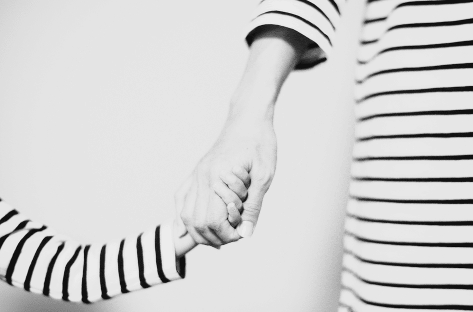 mother and child holding hands wearing striped shirts