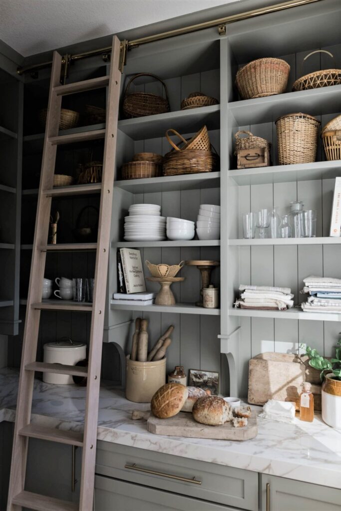 gray open kitchen shelving with marble countertops