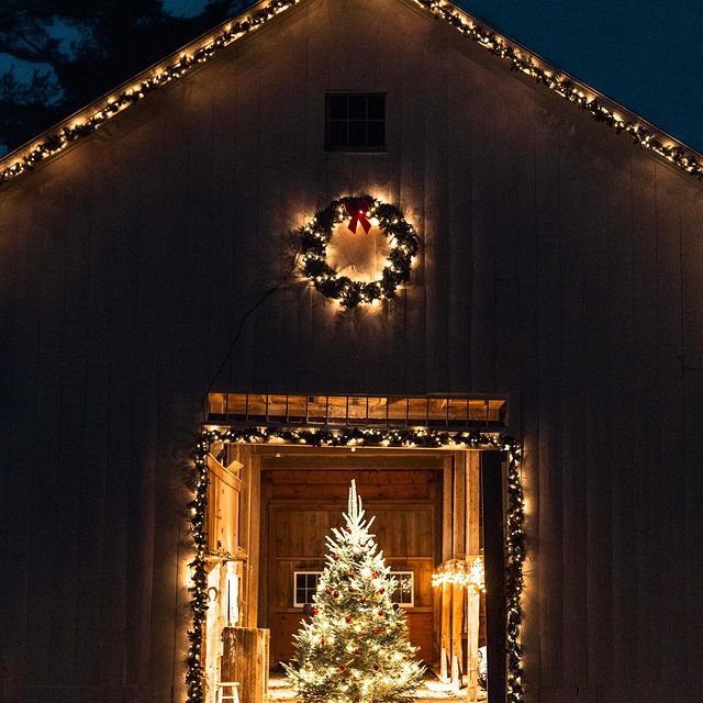 barn with wreath lit up