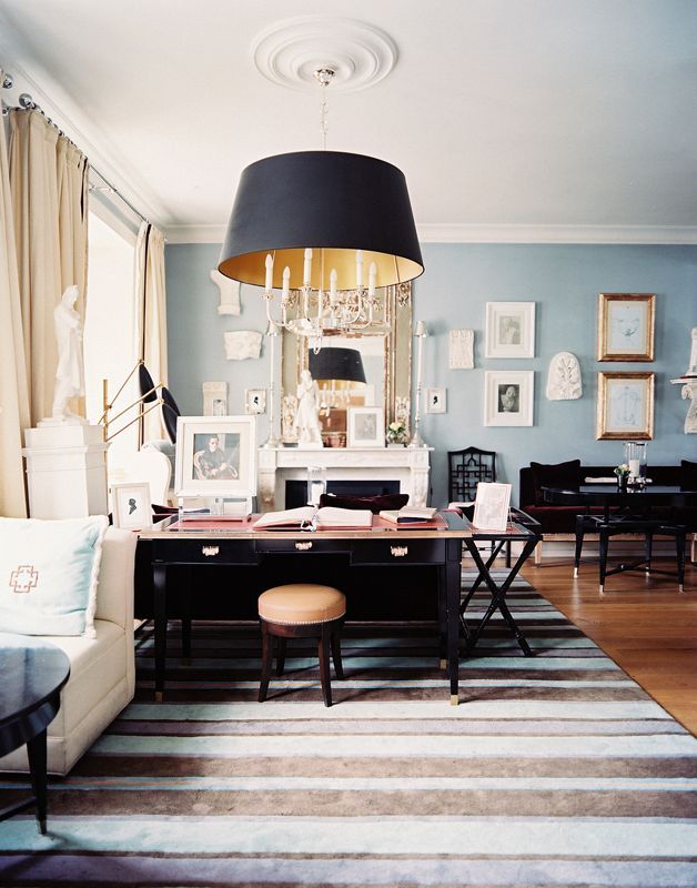 study with oversized ceiling pendant and striped rug