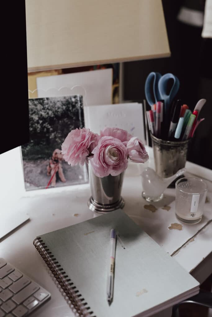 desk with ranunculus in a silver julep cup