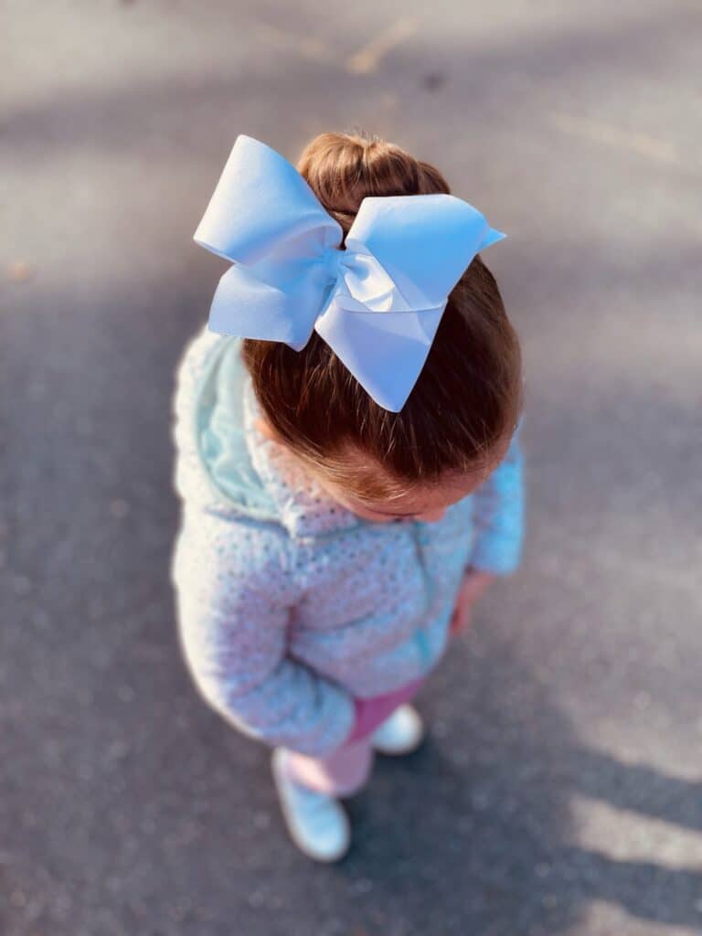 little girl in floral puffer jacket