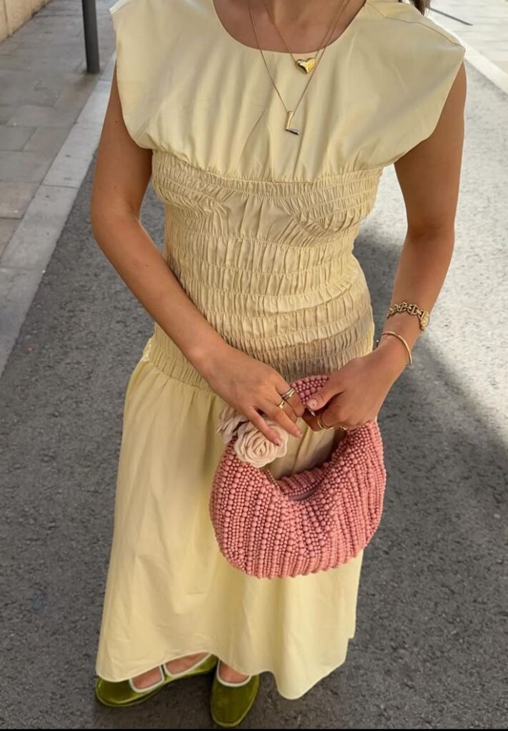 yellow dress with pink raffia bag
