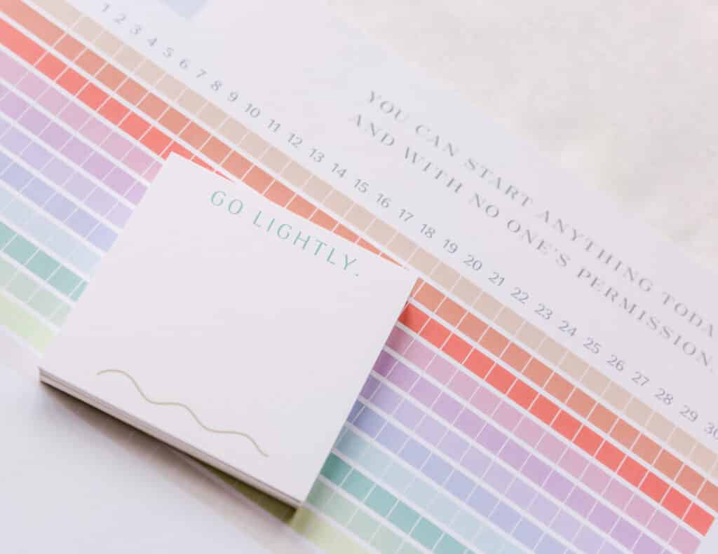 Magpie x Mamey “Go Lightly” post-it pads stacked on matching notepad, styled on fabric background