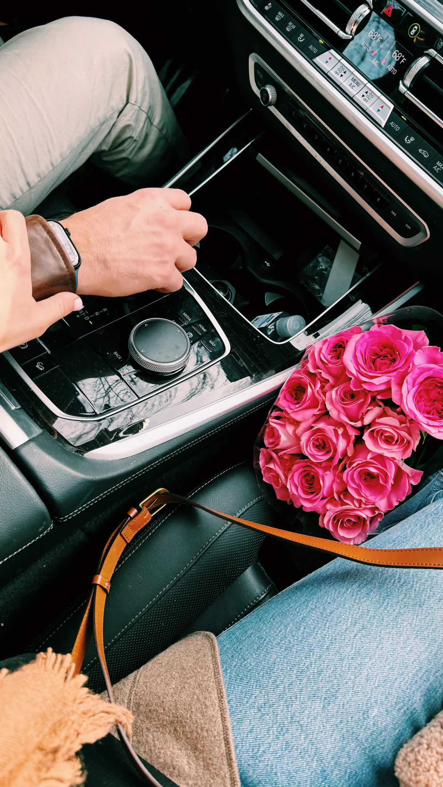 Husband and wife in car holding hands