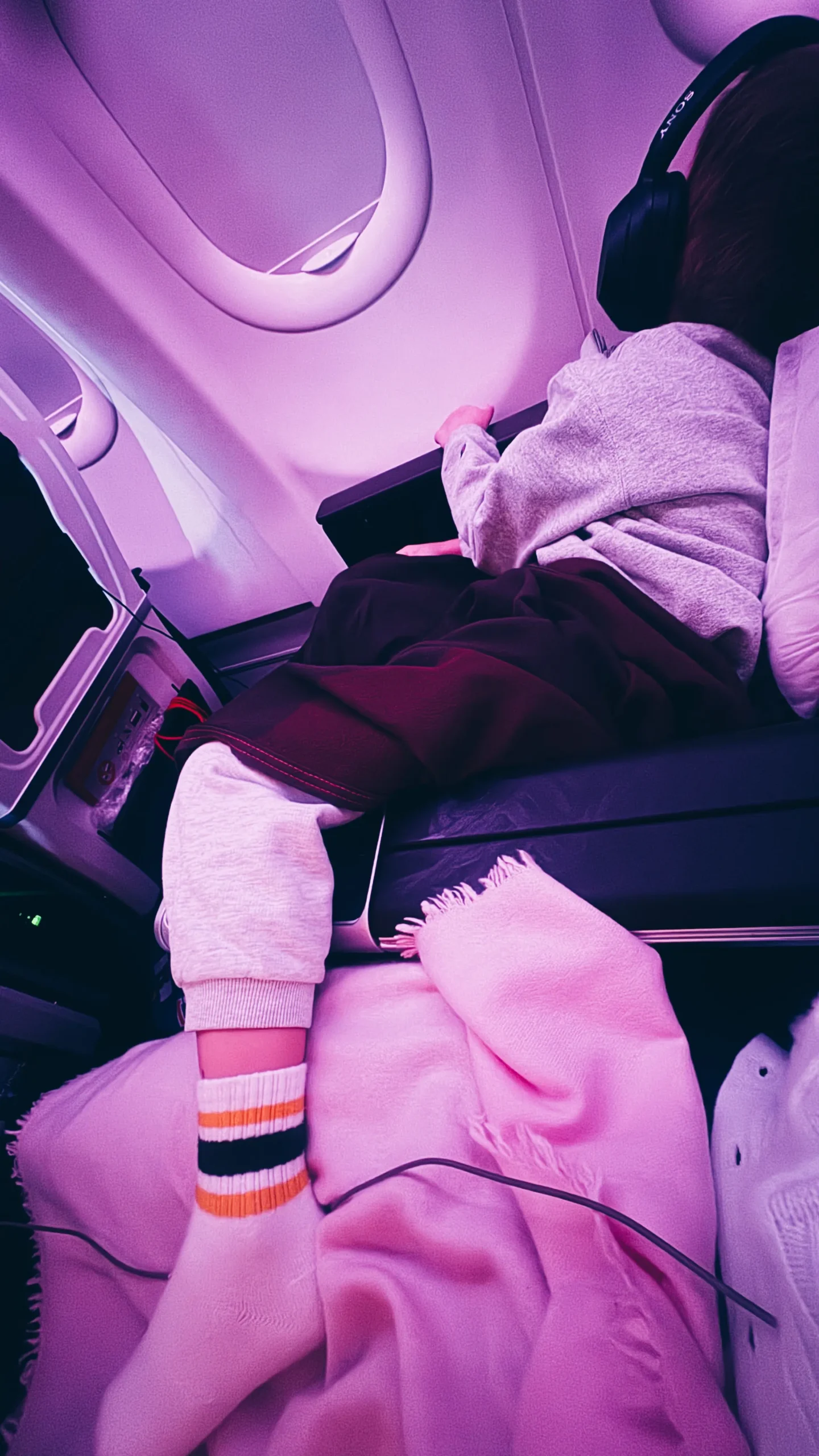 child sleeping on airplane
