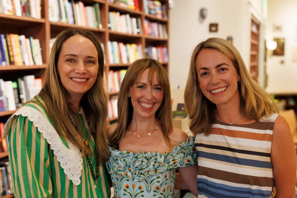 Jen Shoop with Grace Atwood and Jillian Eversole in front of the bookshelves at Ladybird Books in Charleston.