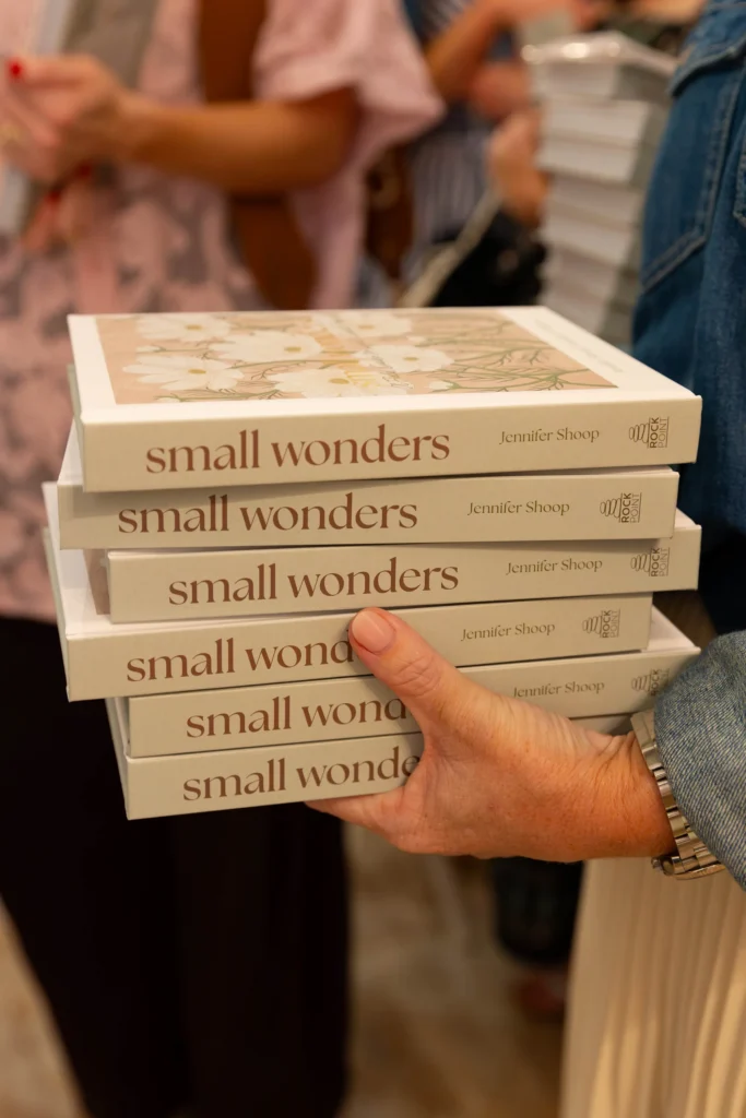 A stack of Small Wonders books held in a guest’s arms at the Raleigh tour stop.